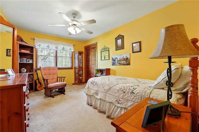 bedroom with carpet floors, ceiling fan, and a closet