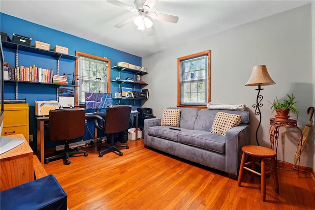 office space featuring a ceiling fan, a healthy amount of sunlight, and wood finished floors