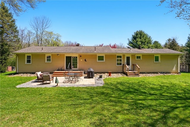 rear view of house with a patio and a lawn