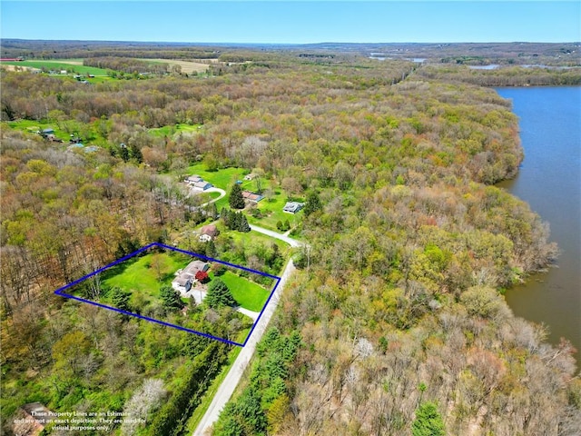 drone / aerial view with a forest view and a water view