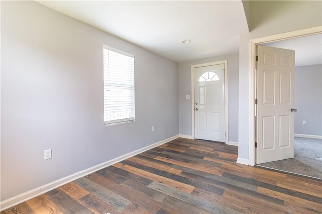 entryway featuring baseboards and wood finished floors