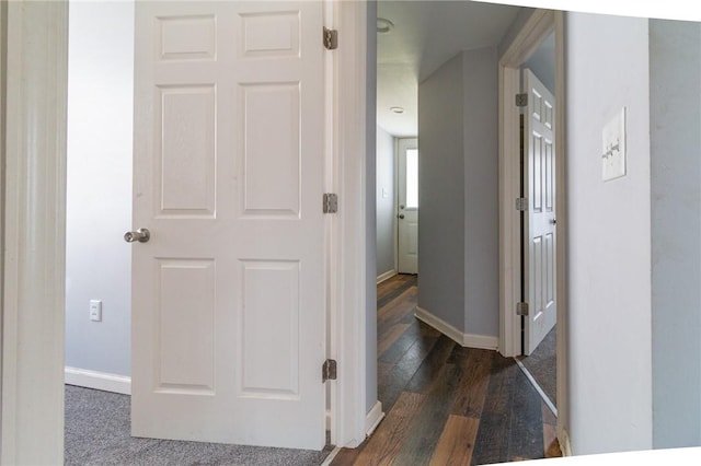 hall with baseboards and dark wood-style floors