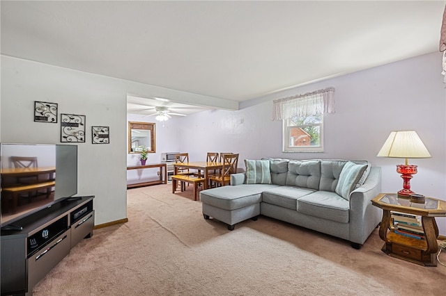 living room with light carpet and a ceiling fan