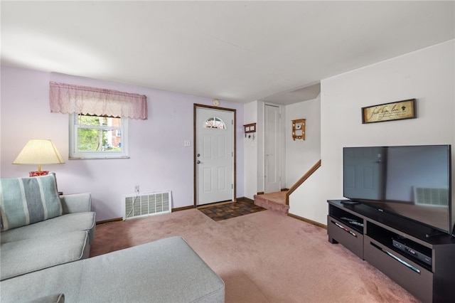 carpeted living room with baseboards and visible vents