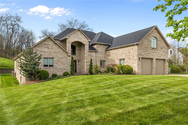 127 Bridle Trl, Peters Twp, PA 15367 - french country style house featuring a garage, a shingled roof, a front lawn, and brick siding
