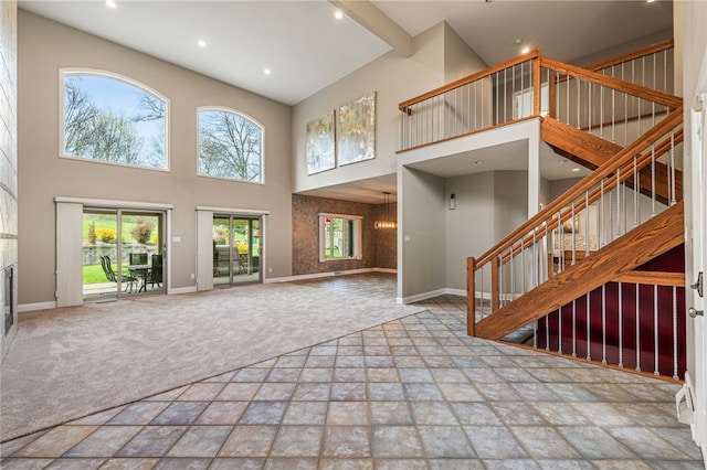 127 Bridle Trl, Peters Twp, PA 15367 - unfurnished living room featuring a high ceiling, stone tile floors, stairs, carpet floors, and recessed lighting