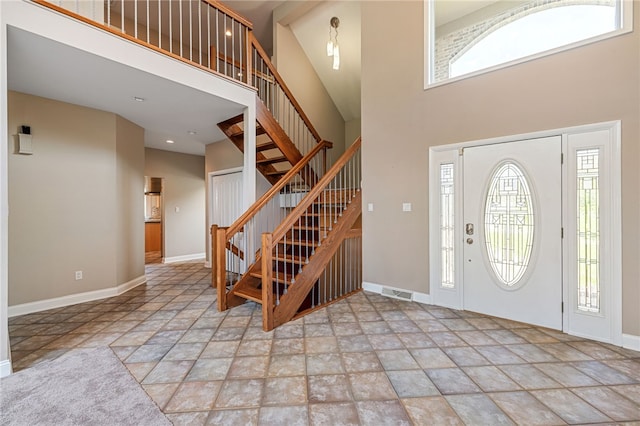 127 Bridle Trl, Peters Twp, PA 15367 - entryway featuring stairs, baseboards, stone finish flooring, a towering ceiling, and visible vents