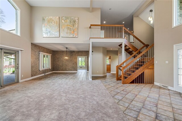 127 Bridle Trl, Peters Twp, PA 15367 - unfurnished living room with stone finish floor, baseboards, and a towering ceiling