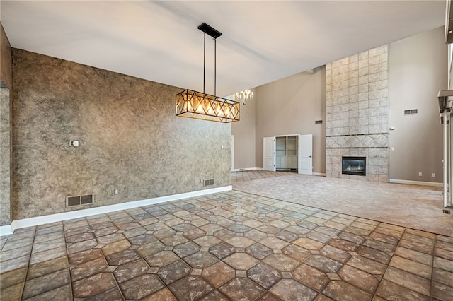 127 Bridle Trl, Peters Twp, PA 15367 - unfurnished living room featuring baseboards, a tile fireplace, a chandelier, and visible vents