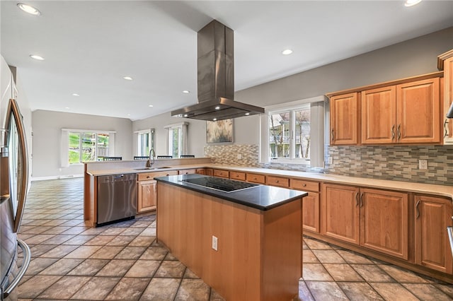 127 Bridle Trl, Peters Twp, PA 15367 - kitchen with a peninsula, island range hood, a sink, backsplash, and stainless steel appliances