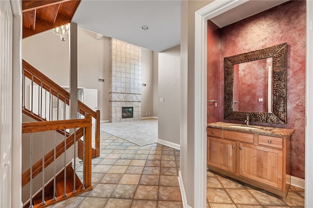 127 Bridle Trl, Peters Twp, PA 15367 - bathroom with baseboards, stone finish flooring, a fireplace, and vanity