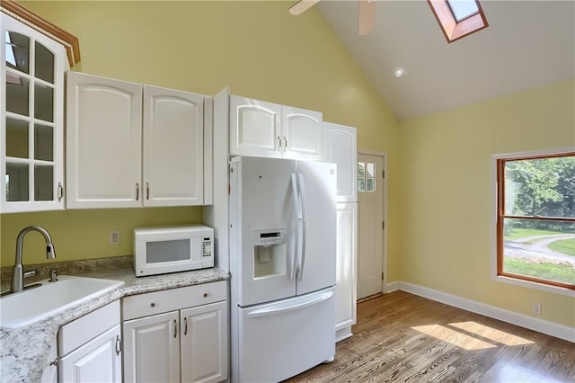 1060 Cherry Hill Rd, North Sewickley Twp, PA 16117 - kitchen featuring white cabinets, a sink, white appliances, wood finished floors, and a skylight