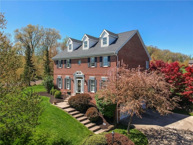 view of front of home with brick siding and a front lawn