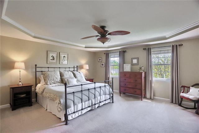 bedroom with carpet flooring, baseboards, ornamental molding, and a raised ceiling