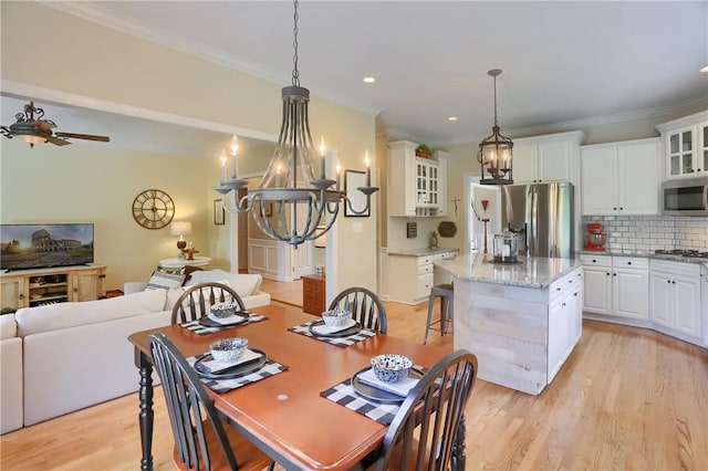 dining room featuring crown molding, light wood finished floors, ceiling fan with notable chandelier, and recessed lighting
