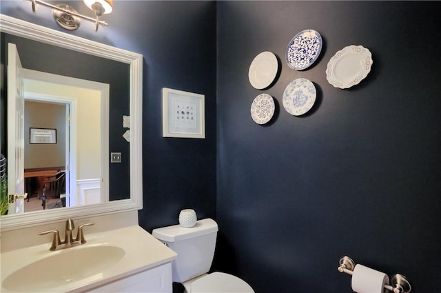 bathroom with toilet and vanity