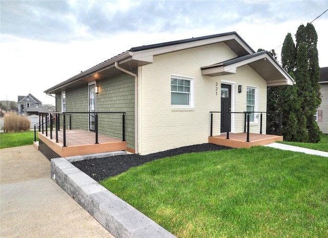 view of side of home featuring a lawn