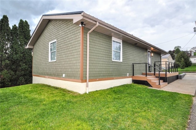 view of property exterior with a yard and a patio