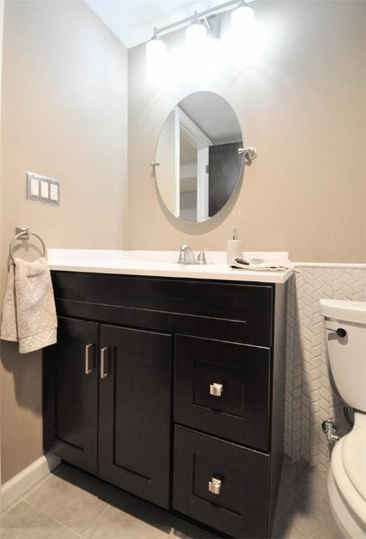 bathroom with vanity, tile patterned floors, and toilet