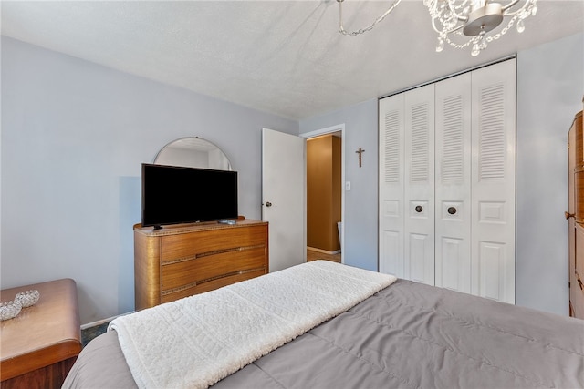 948 Broglie Dr, South Park, PA 15236 - bedroom with baseboards, a closet, and a notable chandelier
