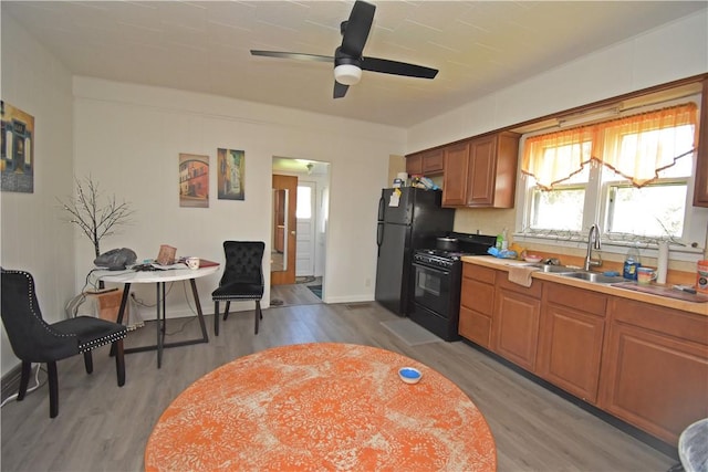 407-409 4th Ave, Ford City Boro, PA 16226 - kitchen featuring a sink, ceiling fan, black appliances, and light wood-style flooring