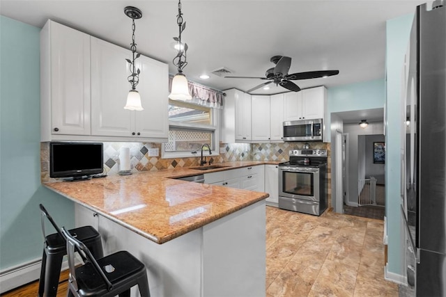 638 Morningstar Dr, Franklin Twp, PA 16117 - kitchen featuring decorative backsplash, a breakfast bar area, appliances with stainless steel finishes, a peninsula, and white cabinetry