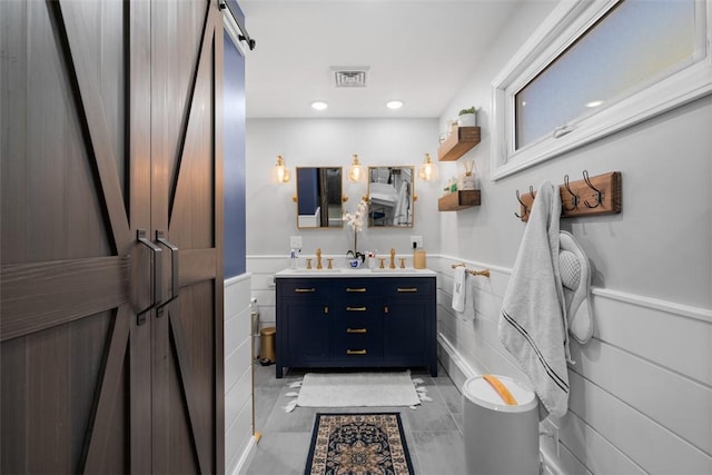 638 Morningstar Dr, Franklin Twp, PA 16117 - bathroom with double vanity, wainscoting, a sink, and visible vents