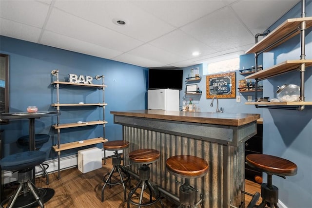 638 Morningstar Dr, Franklin Twp, PA 16117 - bar featuring indoor wet bar, baseboards, a paneled ceiling, and wood finished floors