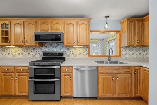 2425 Park Ave, South Franklin, PA 15301 - kitchen featuring a sink, appliances with stainless steel finishes, light wood-type flooring, and light countertops