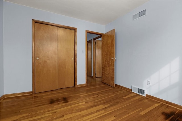 2425 Park Ave, South Franklin, PA 15301 - unfurnished bedroom featuring baseboards, a closet, wood finished floors, and visible vents