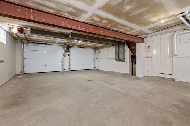 2425 Park Ave, South Franklin, PA 15301 - garage featuring a garage door opener and concrete block wall