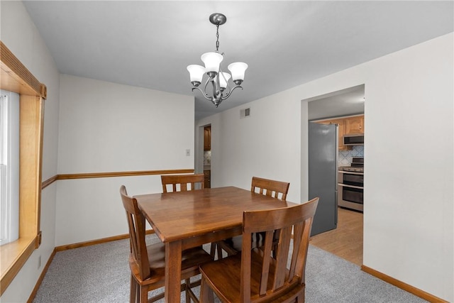 2425 Park Ave, South Franklin, PA 15301 - dining space with light colored carpet, baseboards, a chandelier, and visible vents