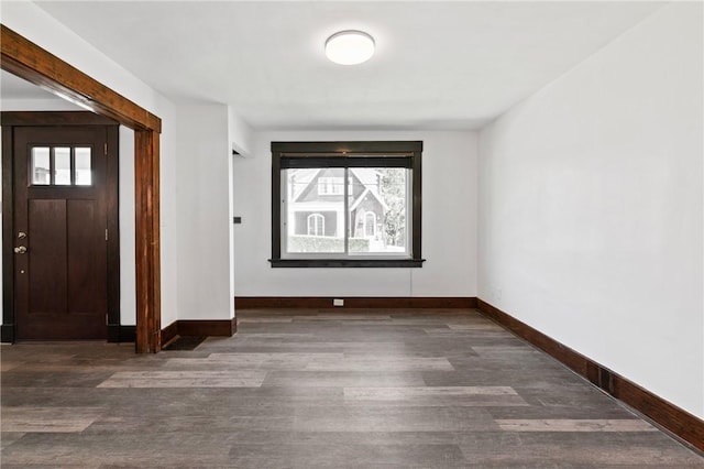 entryway featuring baseboards, wood finished floors, and a healthy amount of sunlight