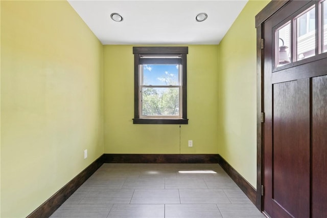 unfurnished bedroom featuring baseboards and tile patterned floors
