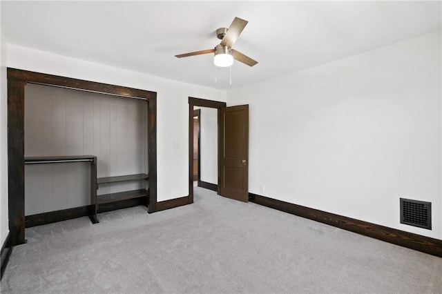 unfurnished bedroom with ceiling fan, visible vents, baseboards, a closet, and carpet