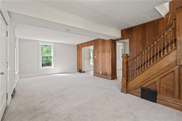 1313 Albert St, New Castle/2Nd, PA 16105 - unfurnished living room featuring visible vents, carpet floors, baseboards, wooden walls, and stairway