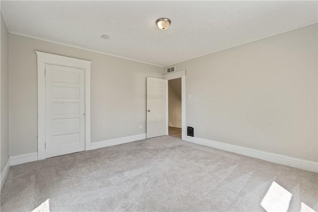 unfurnished bedroom featuring visible vents, carpet flooring, and baseboards