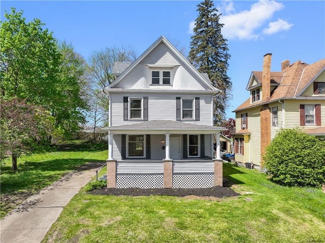 traditional style home featuring covered porch and a front lawn