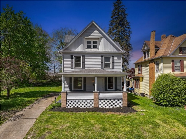 traditional style home with a porch and a front lawn