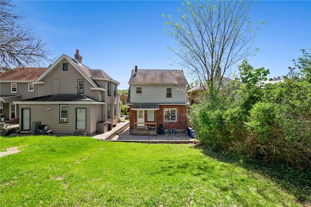1117 Woodbourne Ave, Brookline, PA 15226 - back of house featuring a lawn, a patio, a chimney, and brick siding