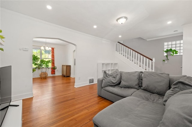 1117 Woodbourne Ave, Brookline, PA 15226 - living room with crown molding, arched walkways, baseboards, and light wood-style floors