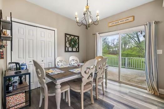 dining space with an inviting chandelier and wood finished floors