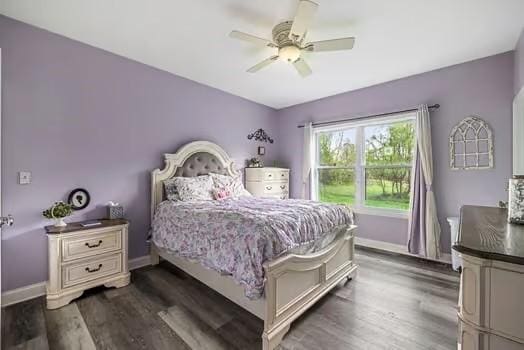 bedroom featuring baseboards, dark wood-type flooring, and ceiling fan