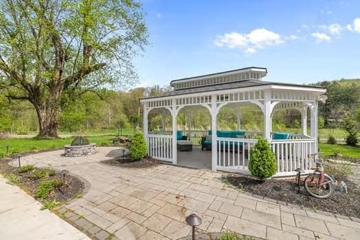 view of community featuring a patio, a gazebo, and a fire pit