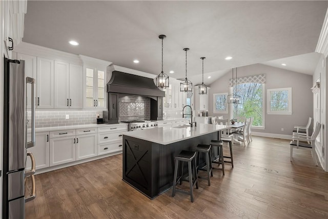 131 Woodford Dr, Adams Twp, PA 16033 - kitchen featuring a kitchen breakfast bar, stainless steel refrigerator, a sink, premium range hood, and range with gas stovetop