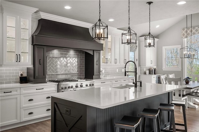 131 Woodford Dr, Adams Twp, PA 16033 - kitchen with a sink, light countertops, a kitchen island with sink, recessed lighting, and gas range