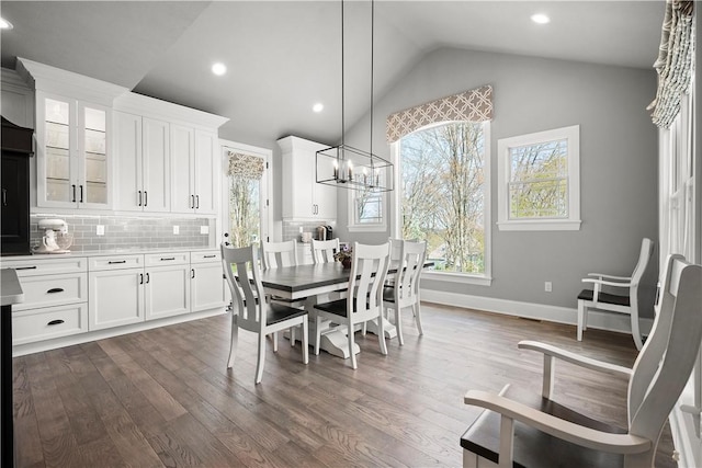 131 Woodford Dr, Adams Twp, PA 16033 - dining room with baseboards, dark wood finished floors, vaulted ceiling, and an inviting chandelier