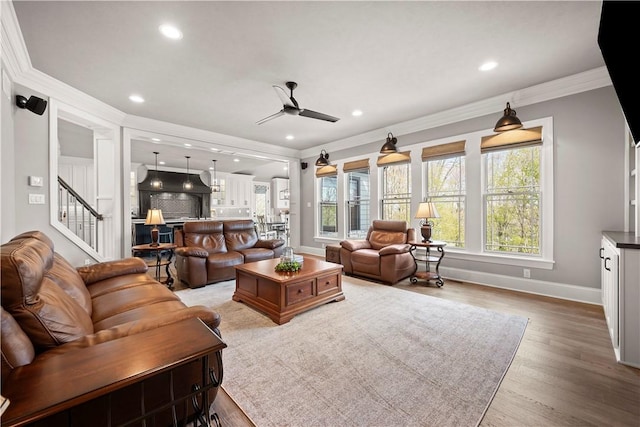 131 Woodford Dr, Adams Twp, PA 16033 - living area with ceiling fan, wood finished floors, baseboards, ornamental molding, and stairs