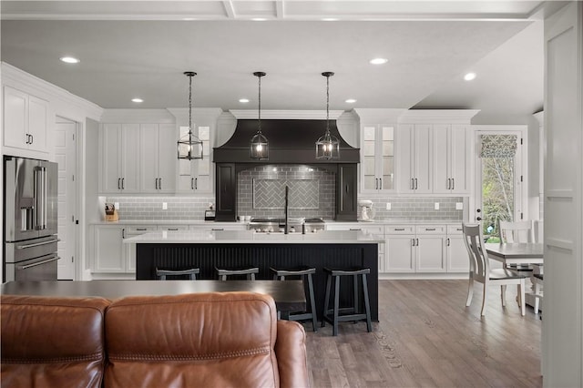 131 Woodford Dr, Adams Twp, PA 16033 - kitchen with a kitchen island with sink, tasteful backsplash, high quality fridge, light countertops, and white cabinetry