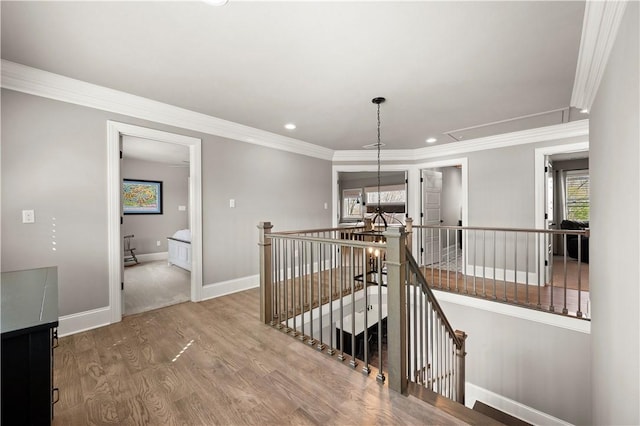 131 Woodford Dr, Adams Twp, PA 16033 - corridor featuring baseboards, attic access, wood finished floors, and an upstairs landing